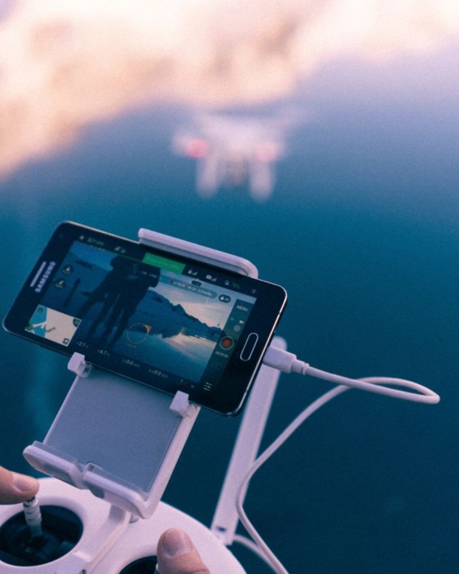 A phone showing a video call on a desk.