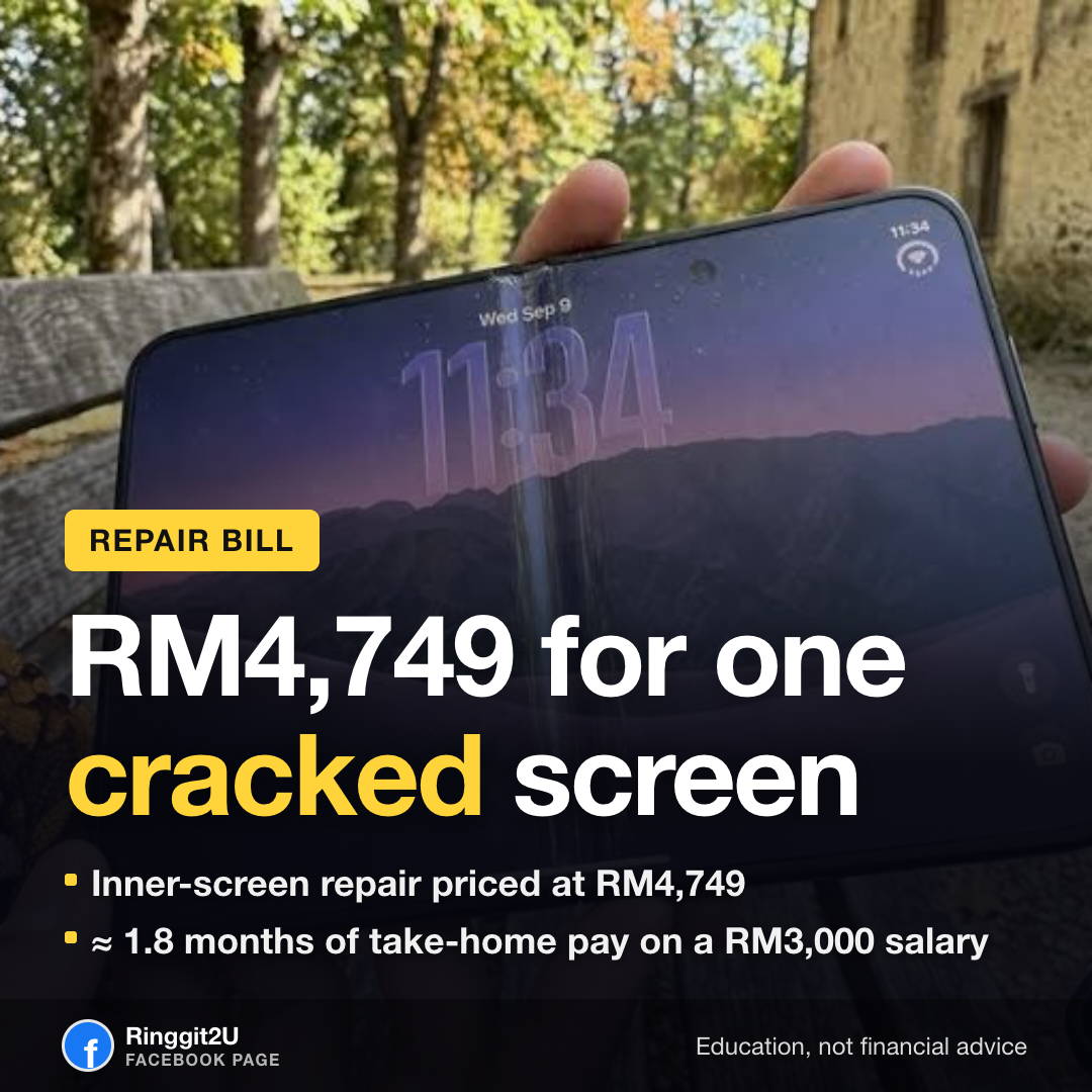 A smartphone with a cracked display being assessed at a repair counter
