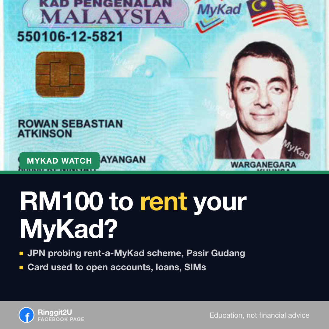 A MyKad identity card held in a hand, with a blurred factory background